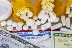 Pills spilled onto medicare card and money