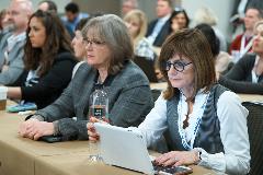 Attendees follow the panelists along by accessing their presentations on their laptops via the meeting app.